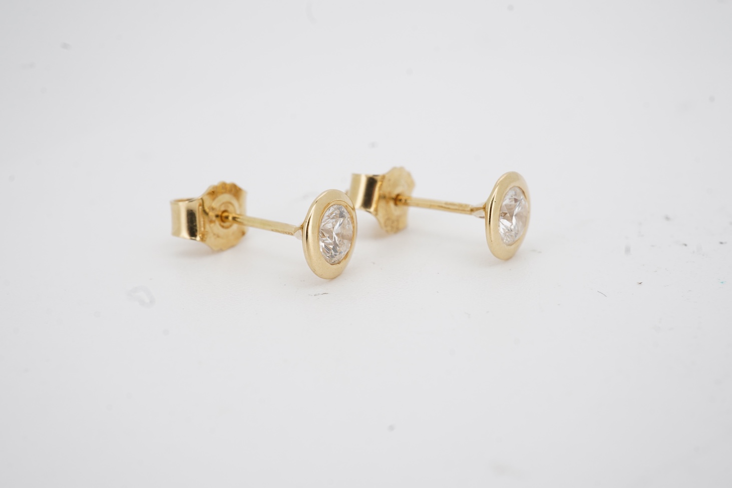A pair of 18k and solitaire diamond set ear studs, each stone weighing approximately 0.25ct, gross weight 1.5 grams.